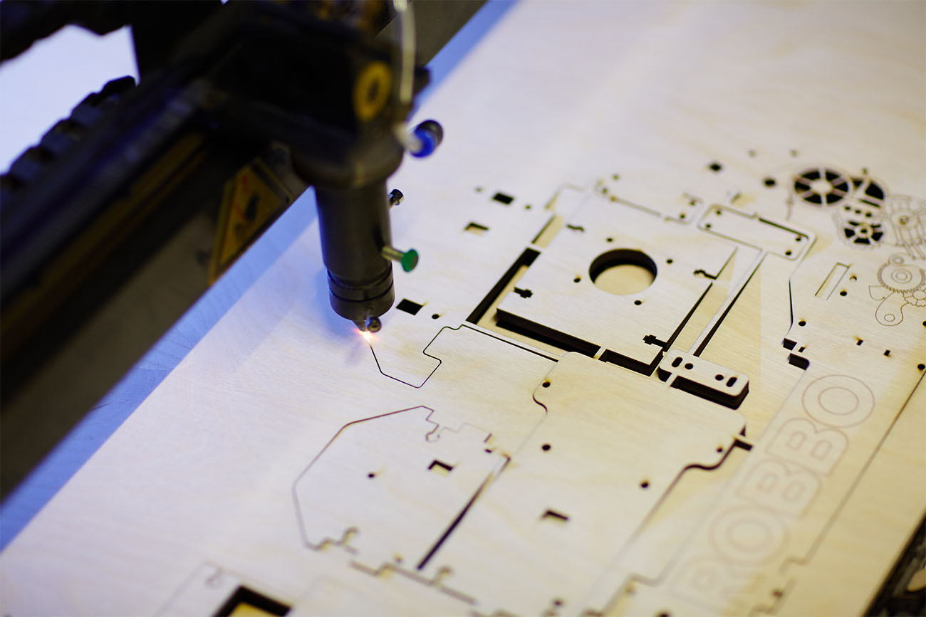 Laser cutter engraving details from plywood